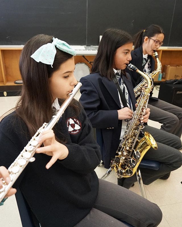 A group of young girls playing musical instruments.