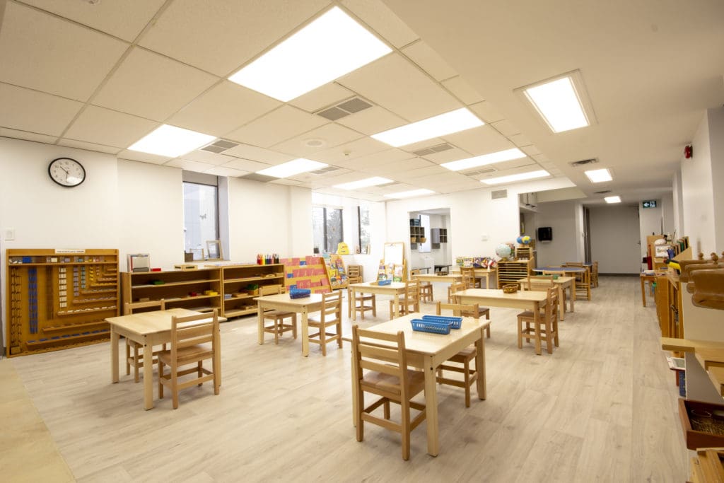 A classroom with tables and chairs in it